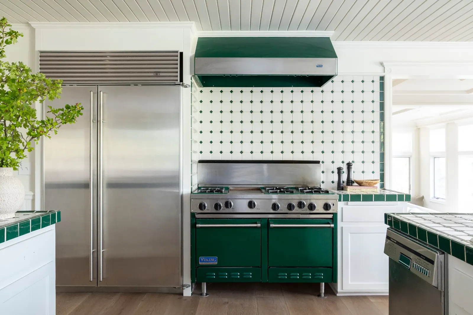 Kitchen with a green range, hood and tiled backsplash